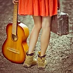 An image of a lady holding a guitar